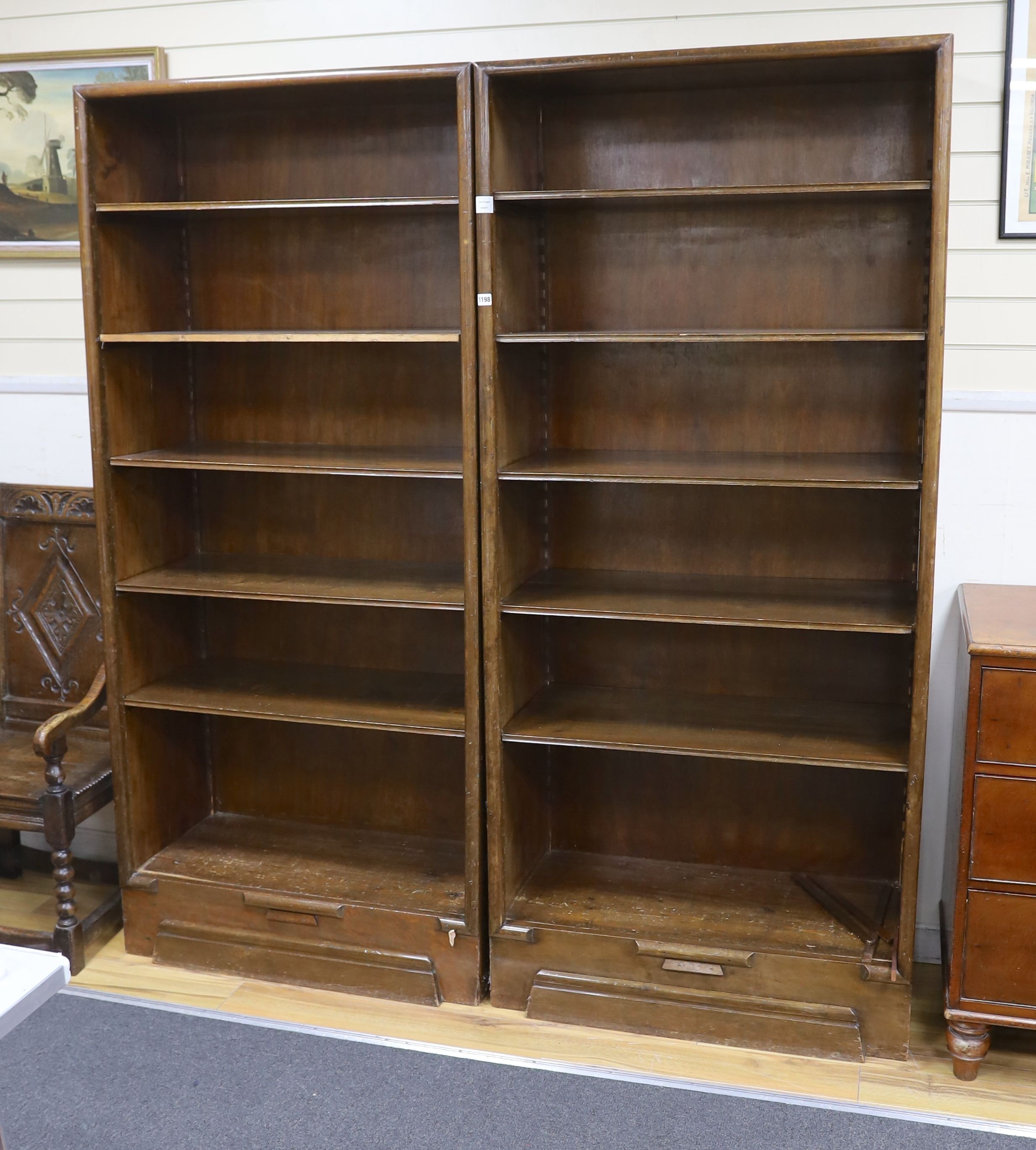 A pair of Hungarian mahogany and pine open fronted bookcases, with adjustable shelving, each width 89cm, depth 40cm, height 200cm